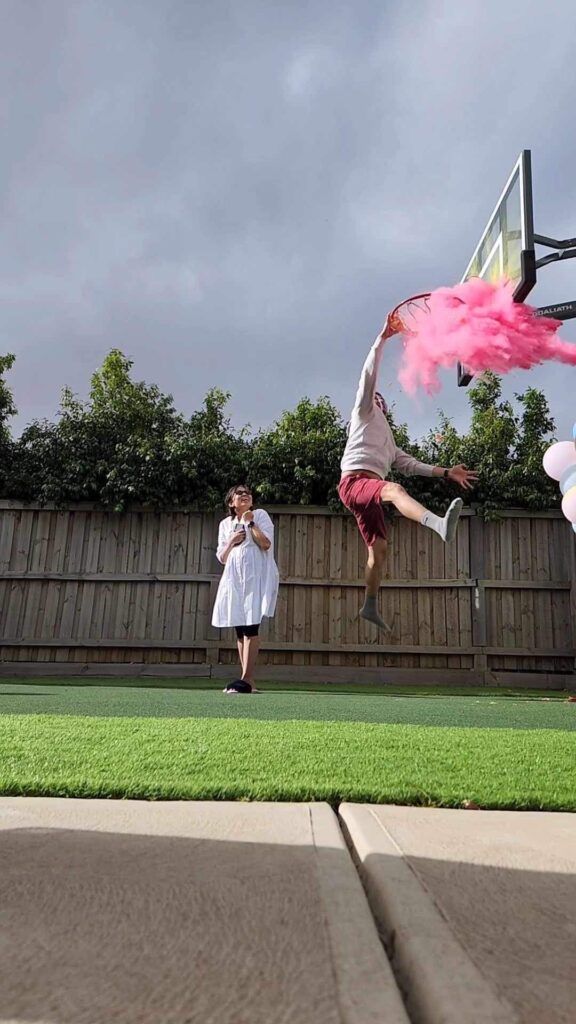 Gender reveal Basket ball slam dunk with pink holi powder